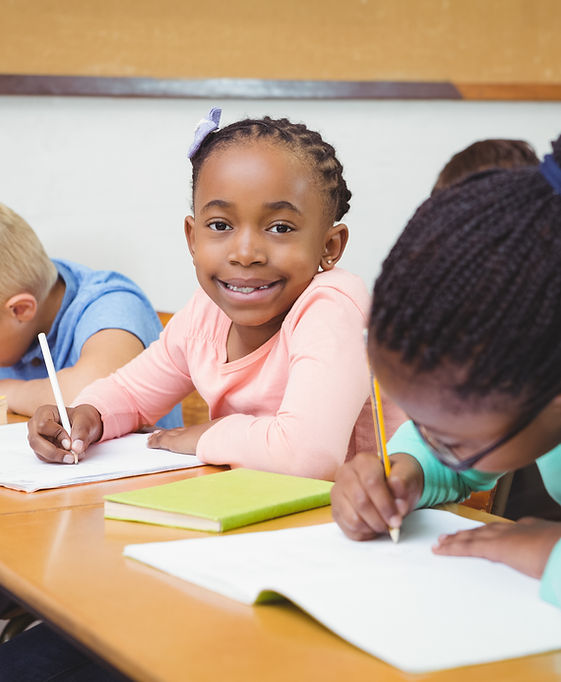 A student writing at her desk